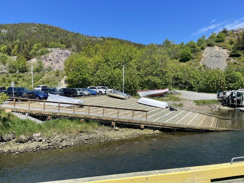 A wooden slip jutting in to the water with boats on it